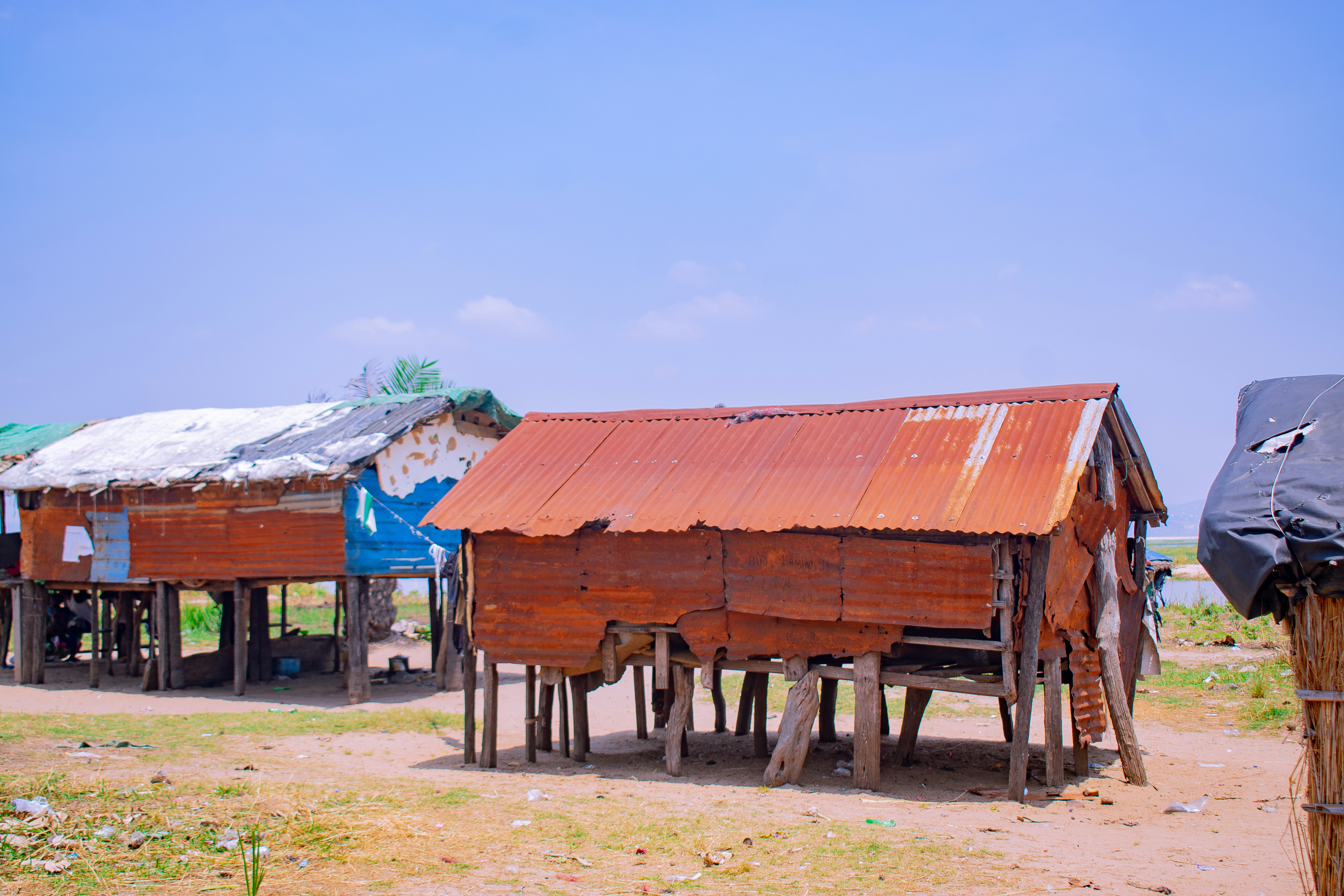 Rustic stilt houses with corrugated metal roofs.