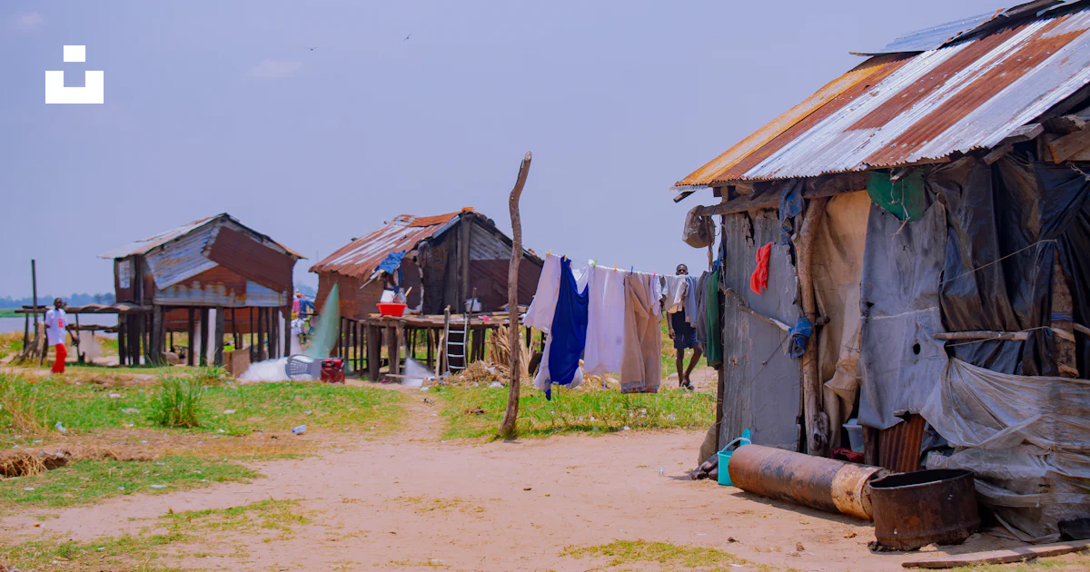 Stilted Community Rustic stilt houses with laundry drying in the sun photo – Free ...