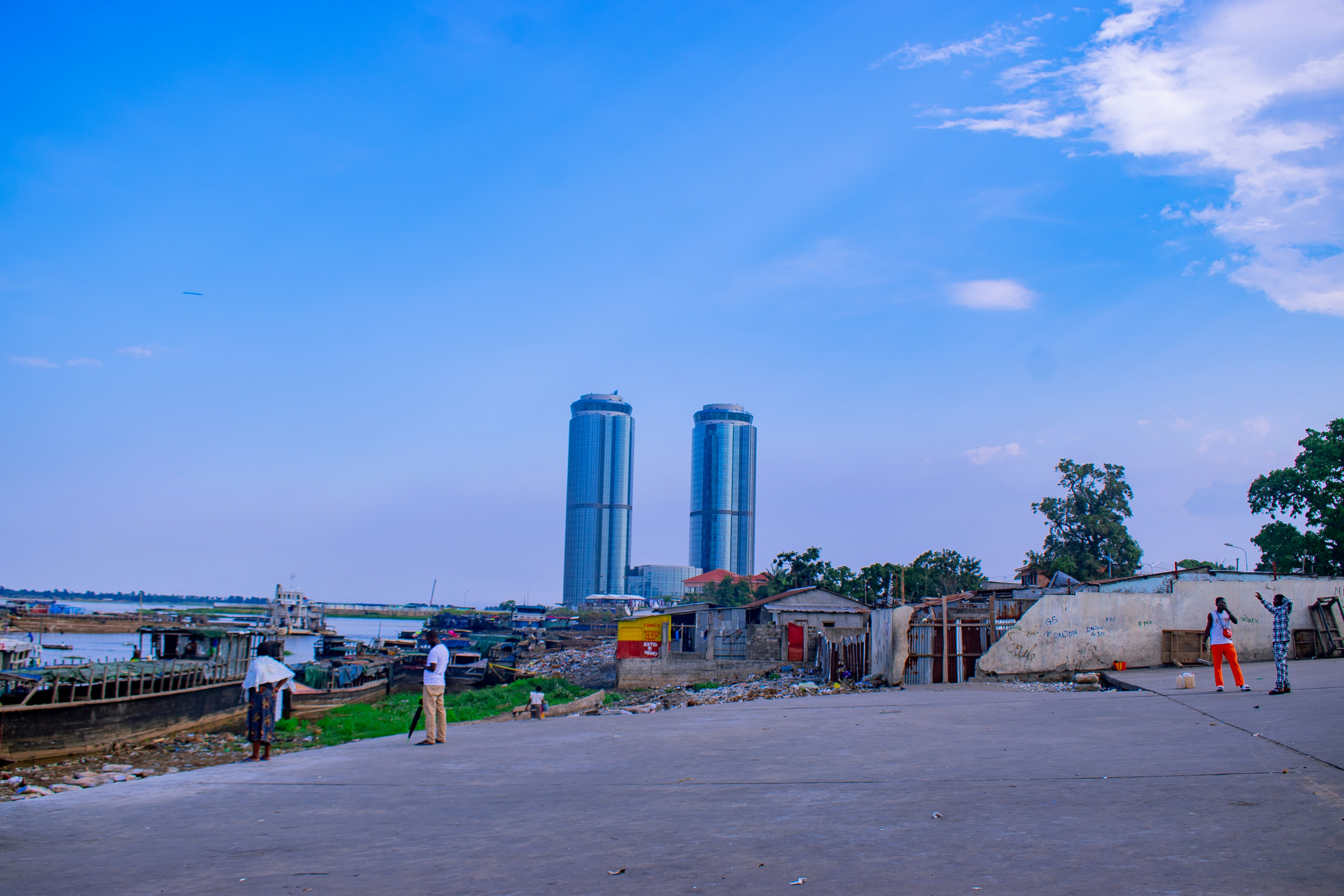 Two modern skyscrapers rise above a town.