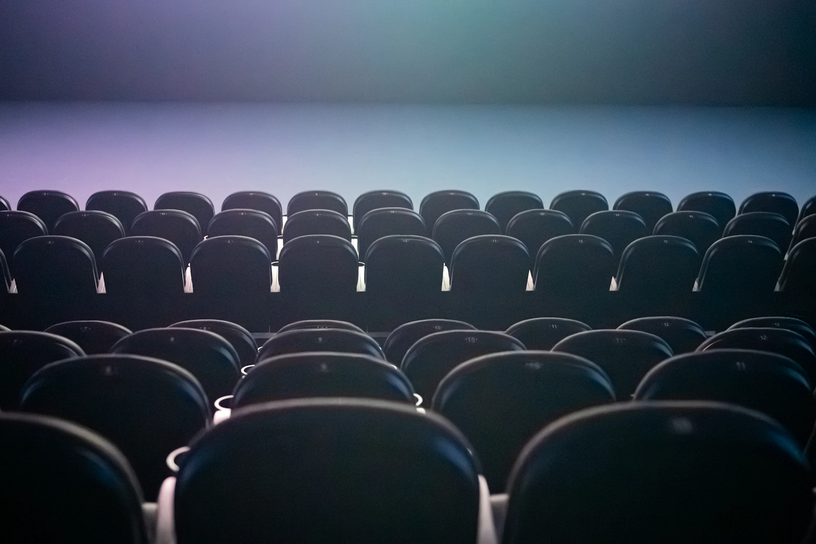 Empty cinema auditorium seats facing the screen