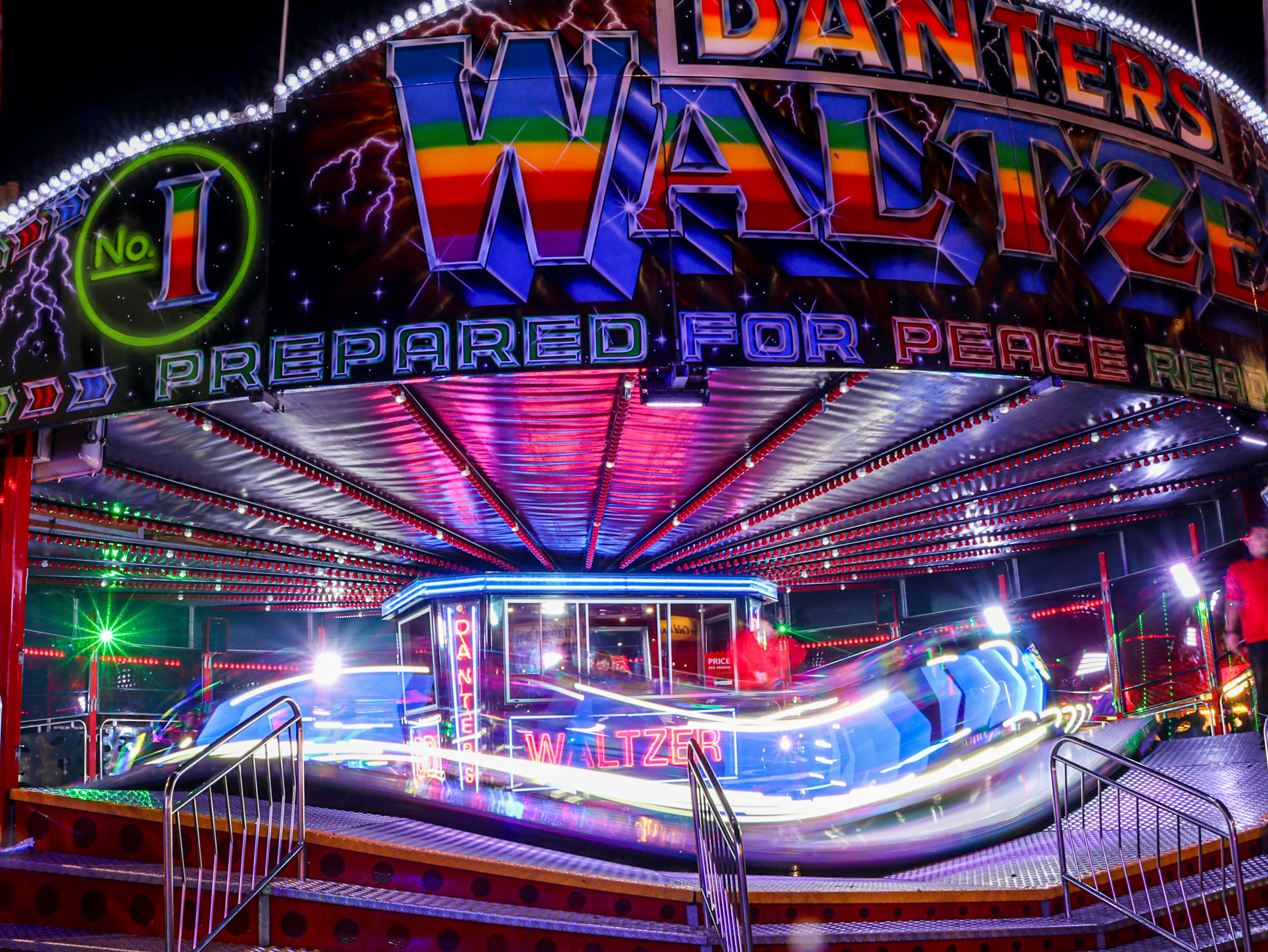 Colorful carnival ride with bright lights at night