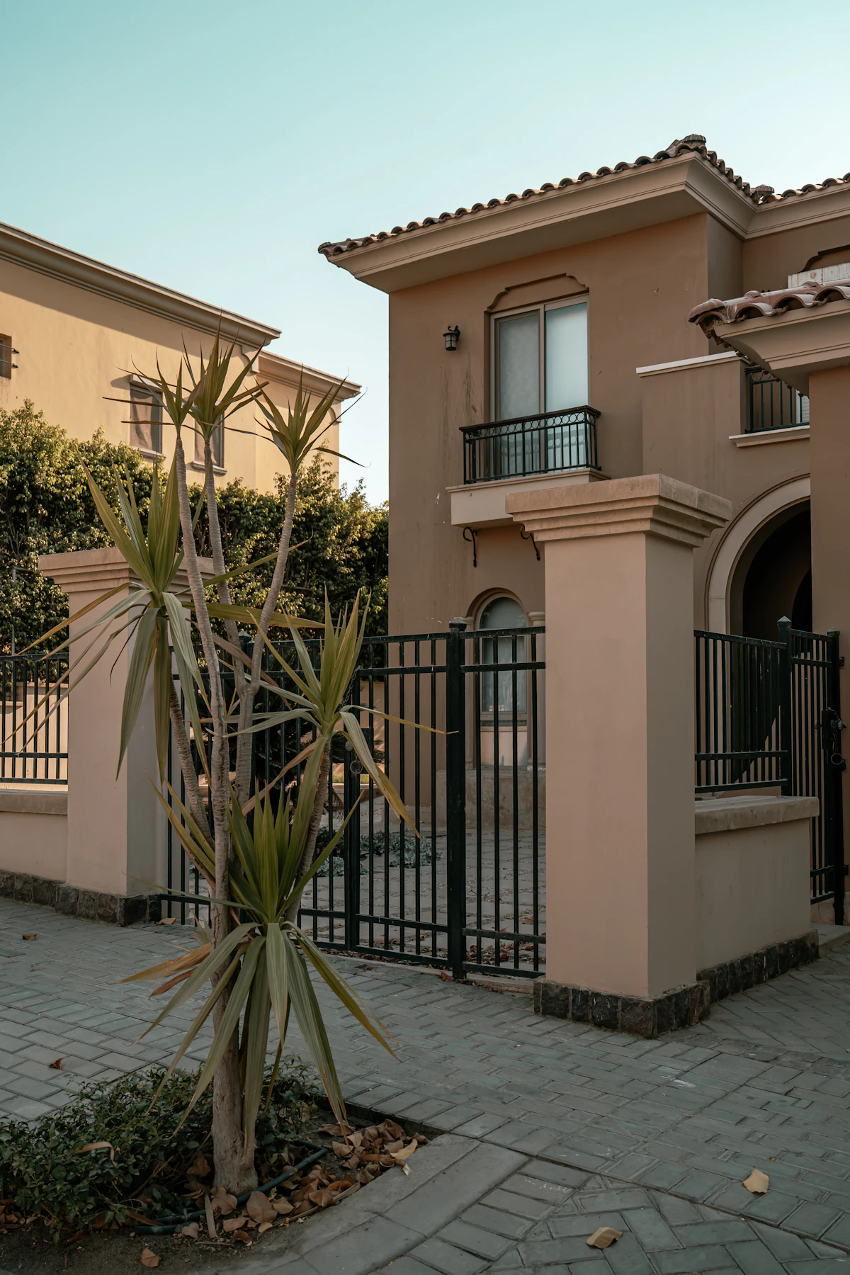 House with a black metal gate and fence