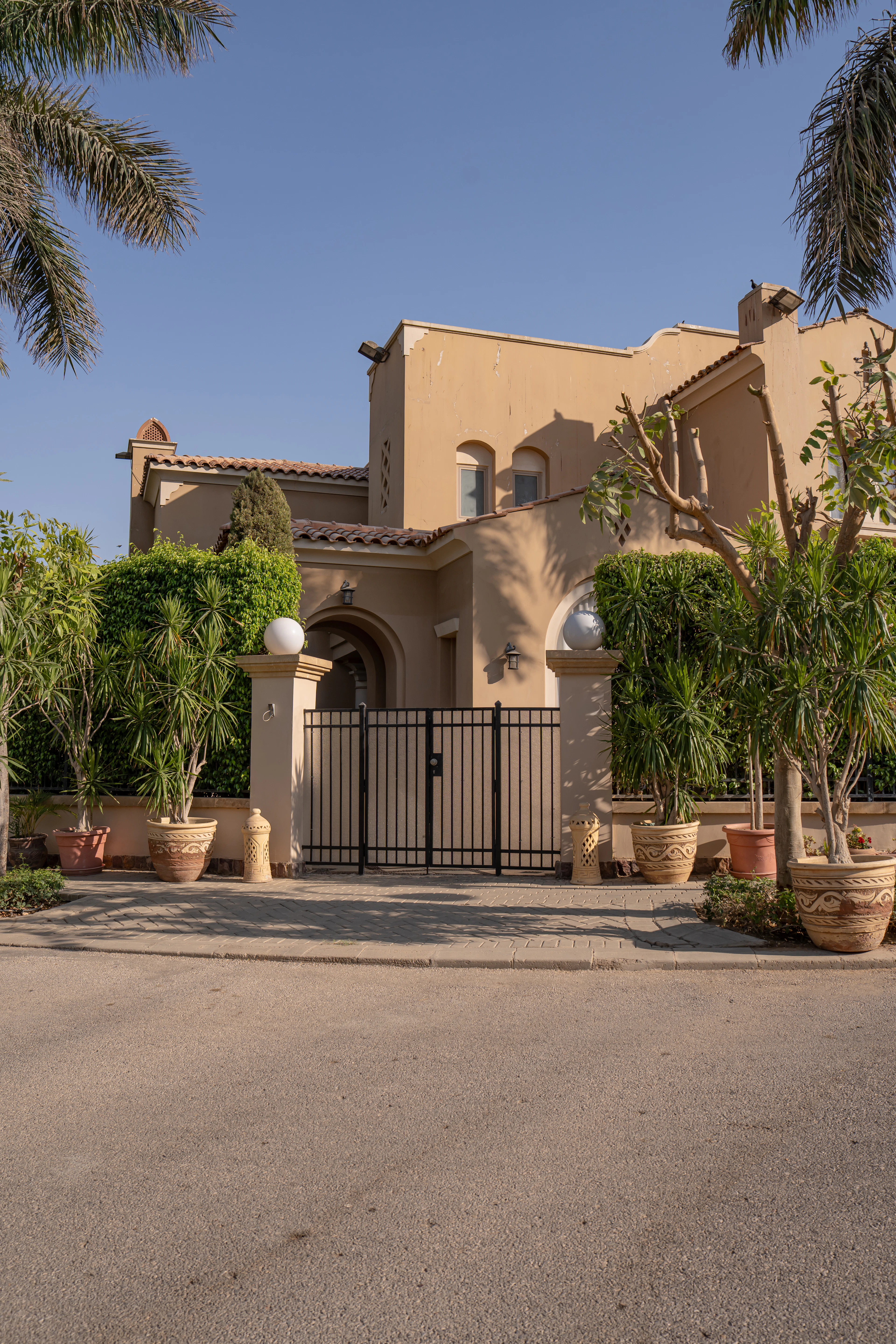 Villa with a gated entrance and greenery