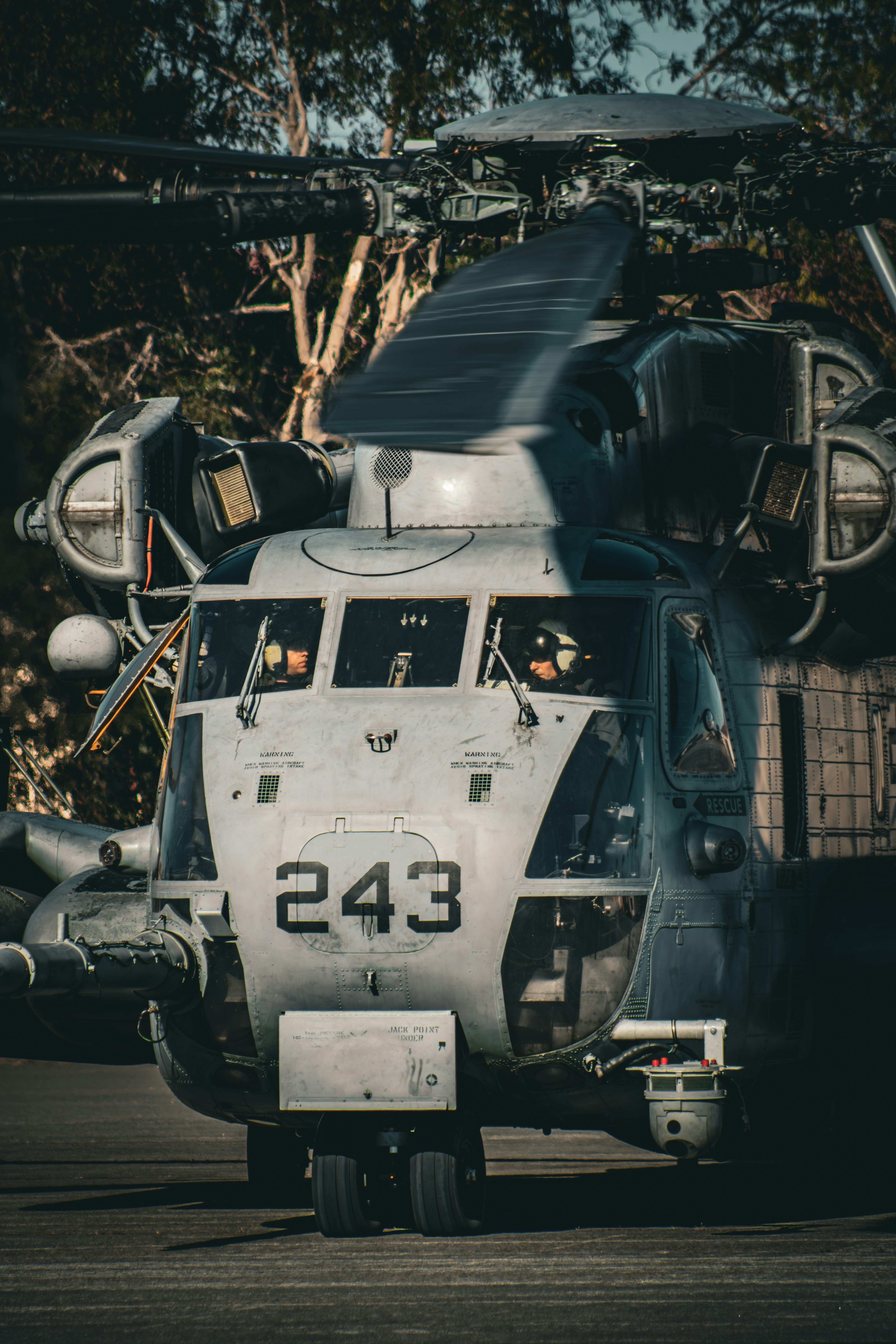 A large military helicopter with the number 243.