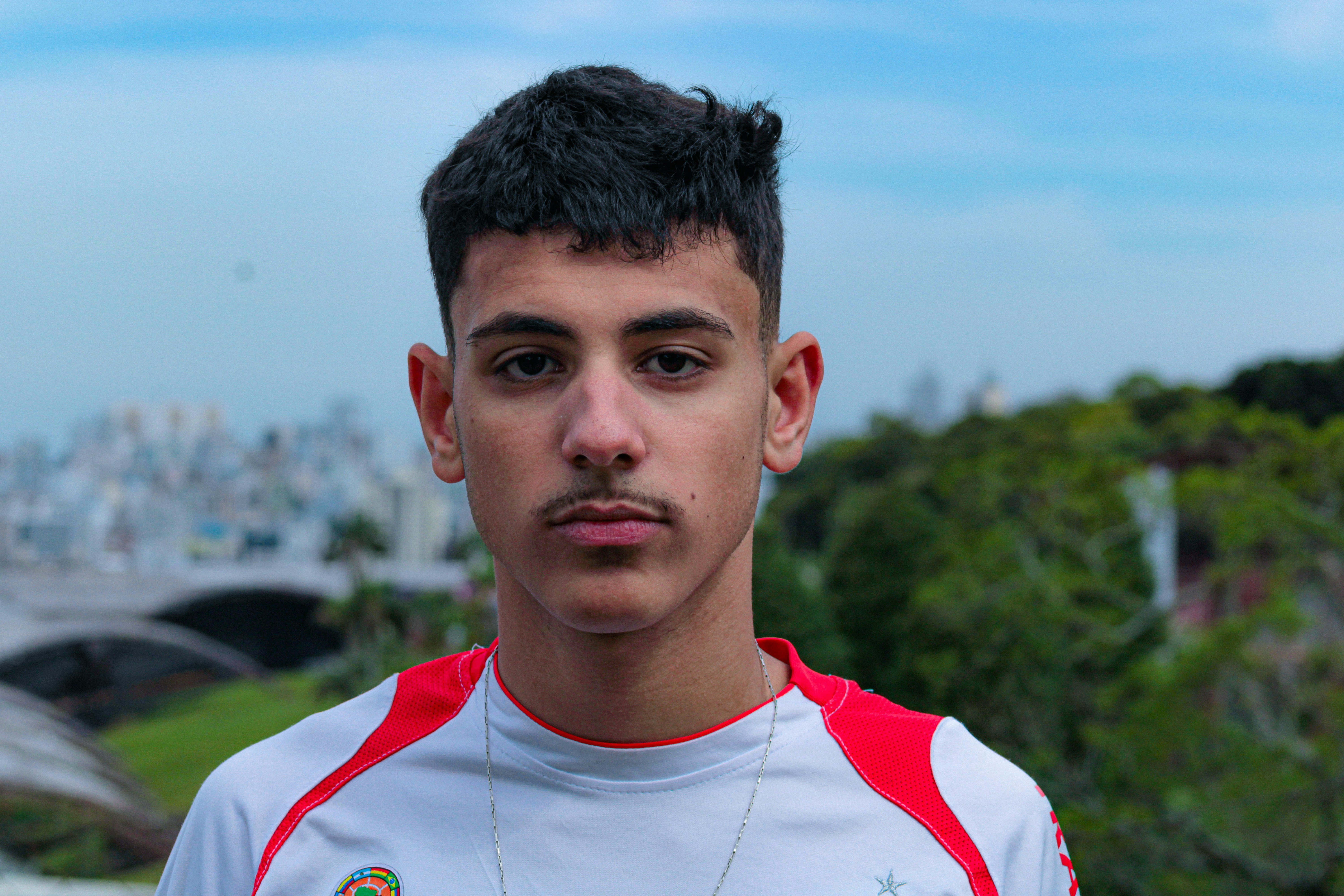 Young man with mustache and short hair outdoors