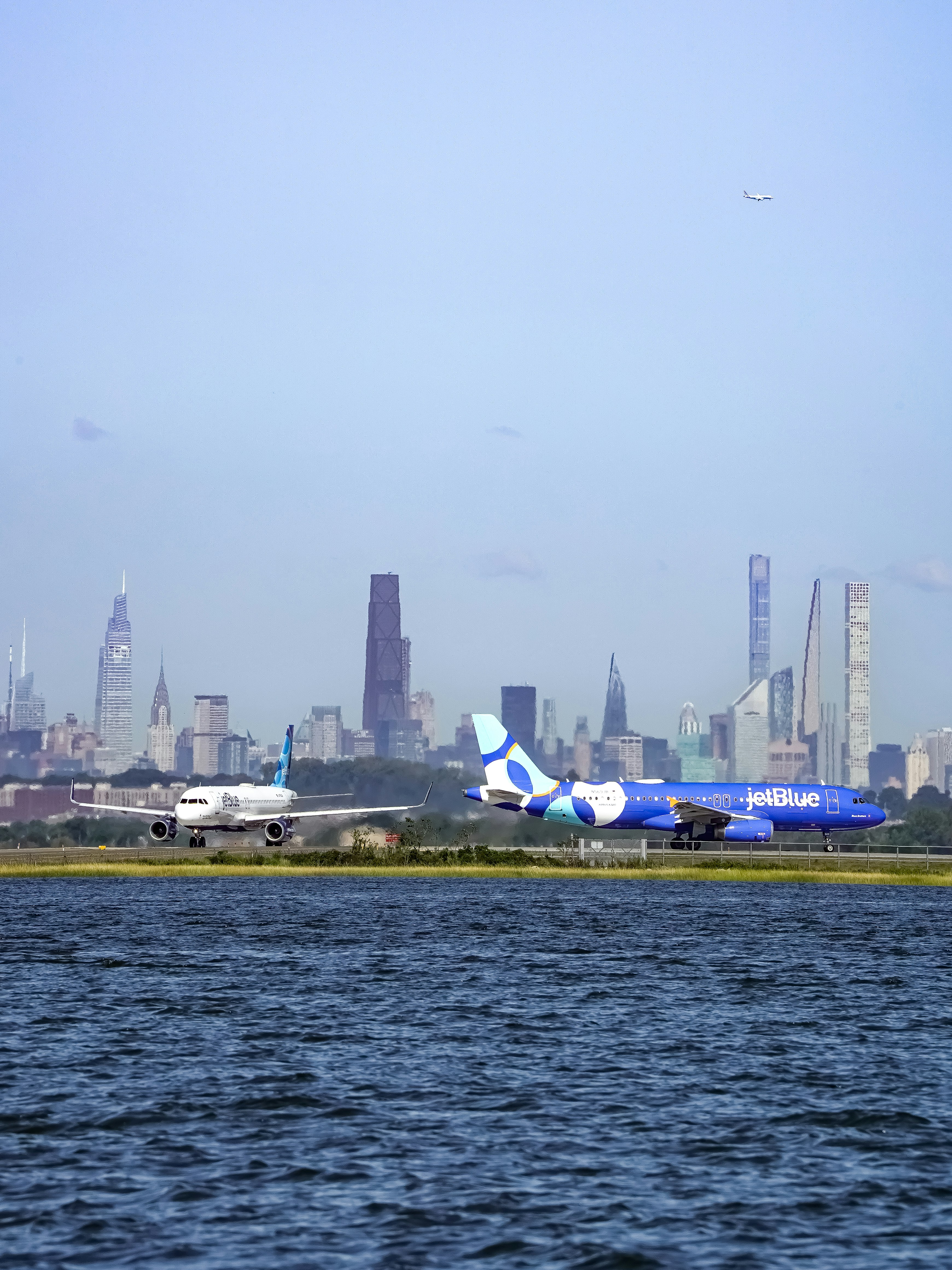Airplanes on tarmac with new york city skyline