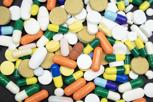Assortment of colorful pills and capsules scattered randomly