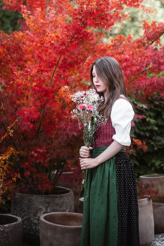 Young woman in traditional dress holding flowers