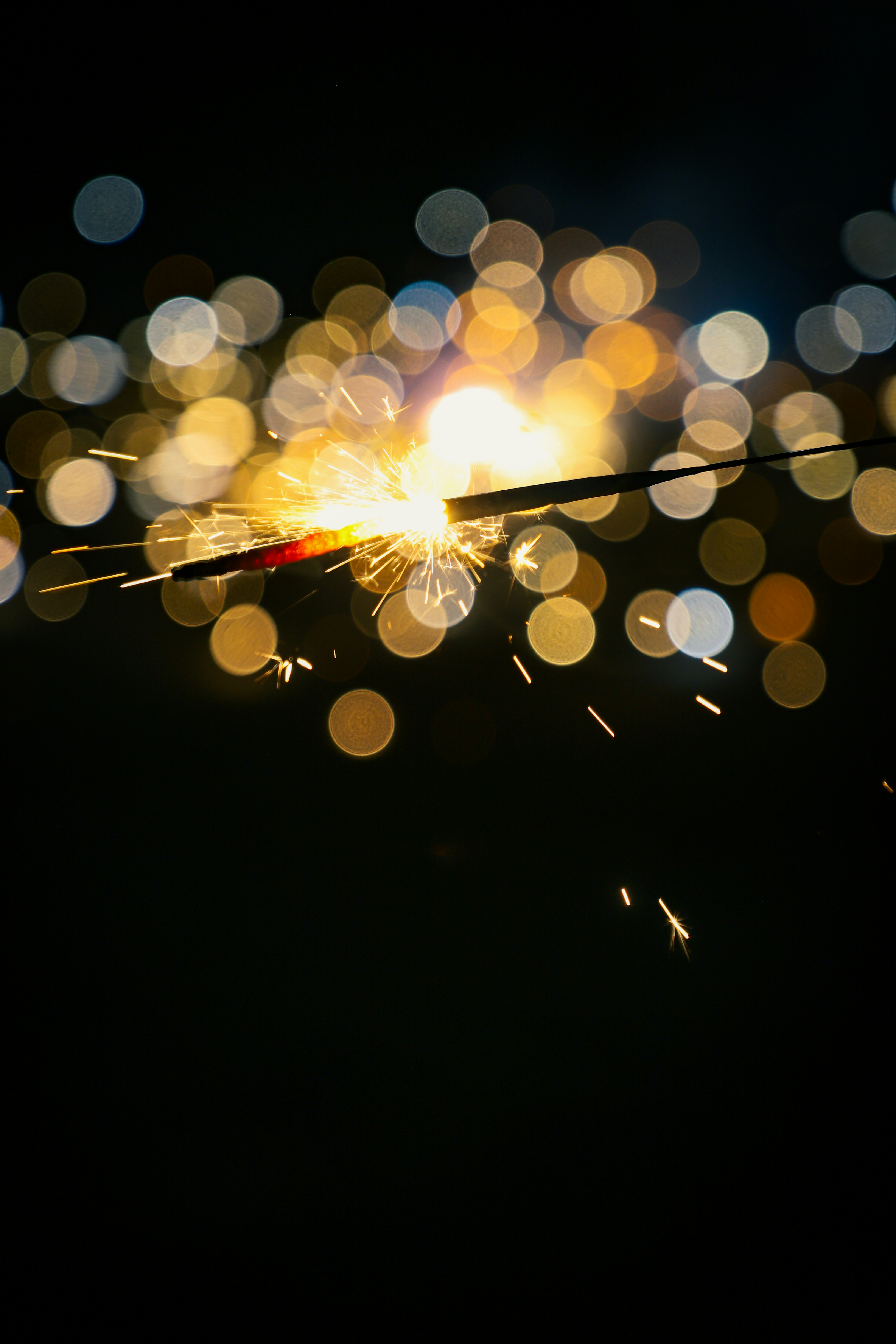 Sparkler with bokeh lights at night