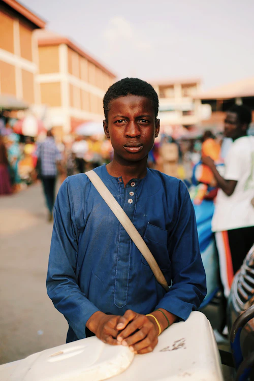 Young man at a busy Nigerian market