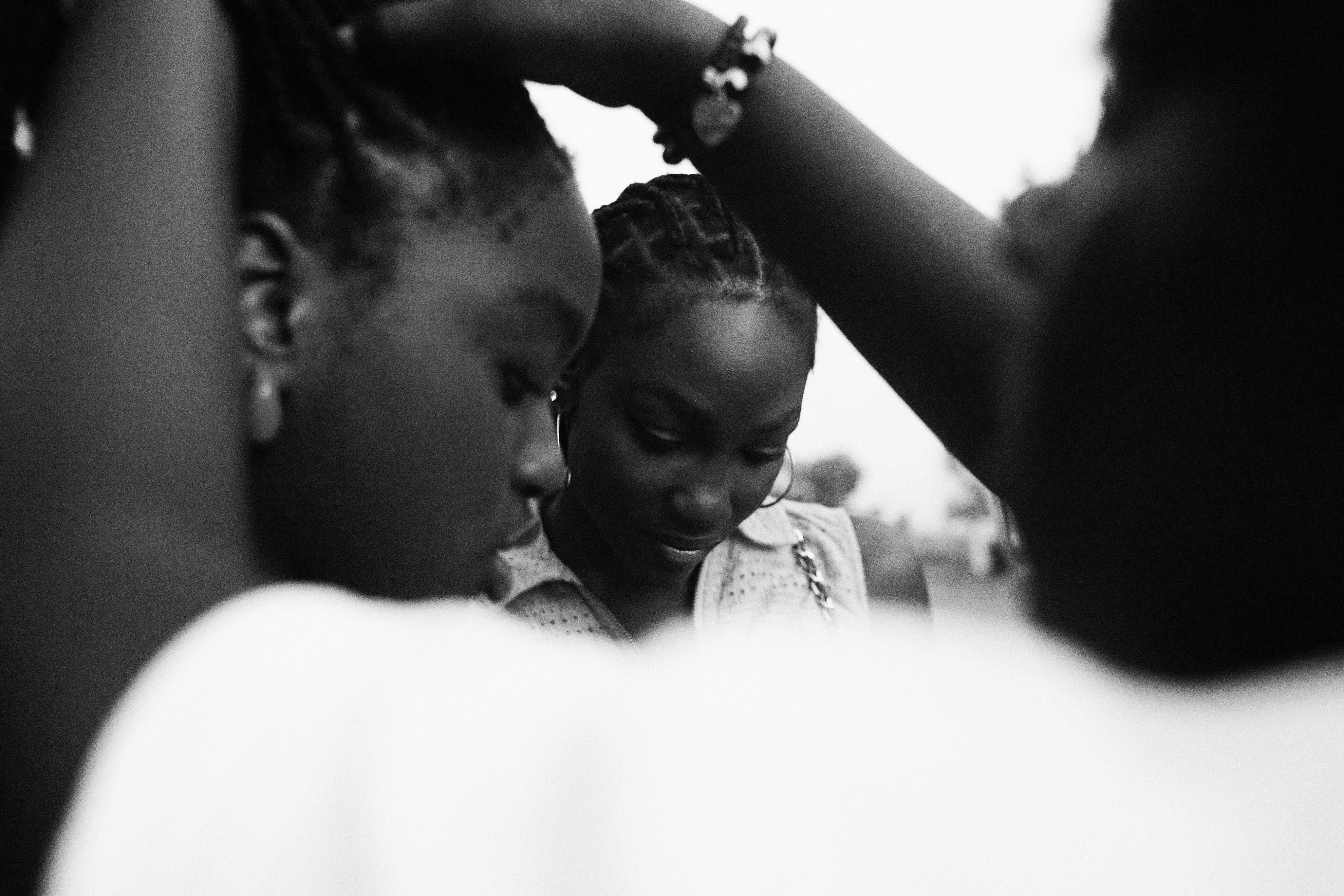 Three women looking down together outdoors