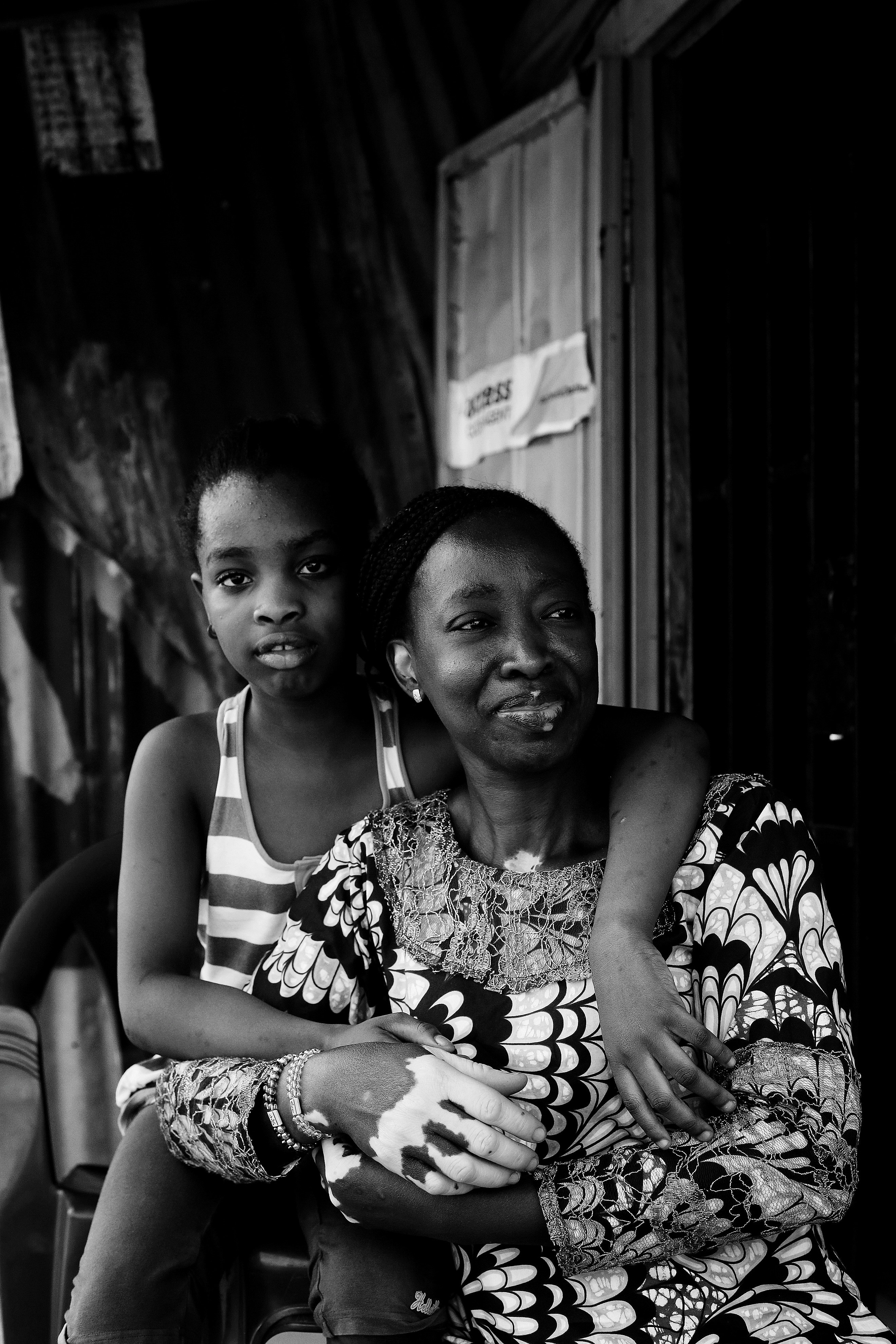 Two women, one young, one older, sit together.