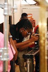 A filmmaker operates a camera on a slider.