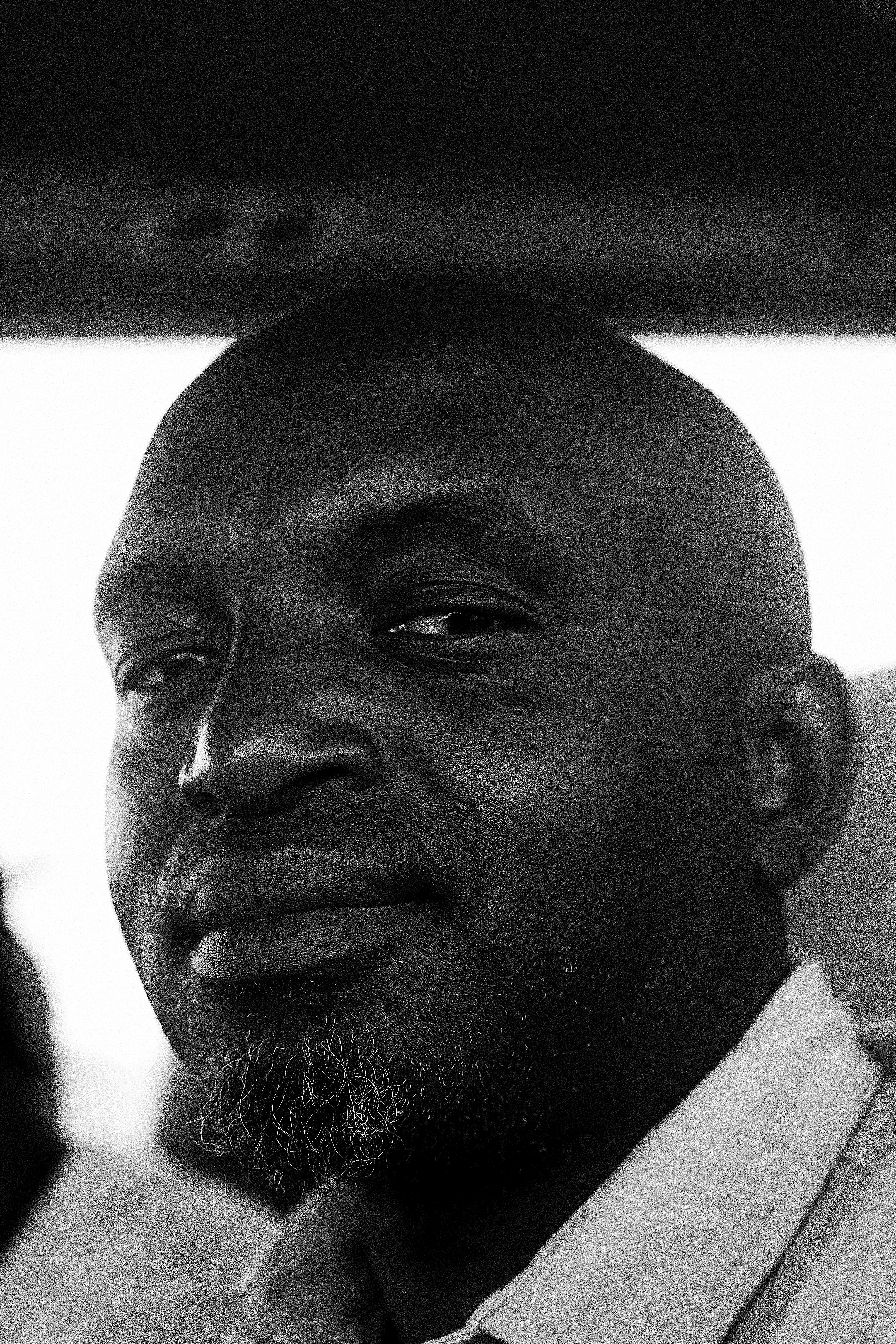 Black and white portrait of a bald man with beard.