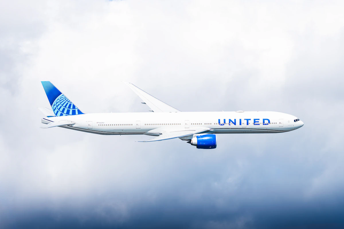 United Airlines jet flying through clouds