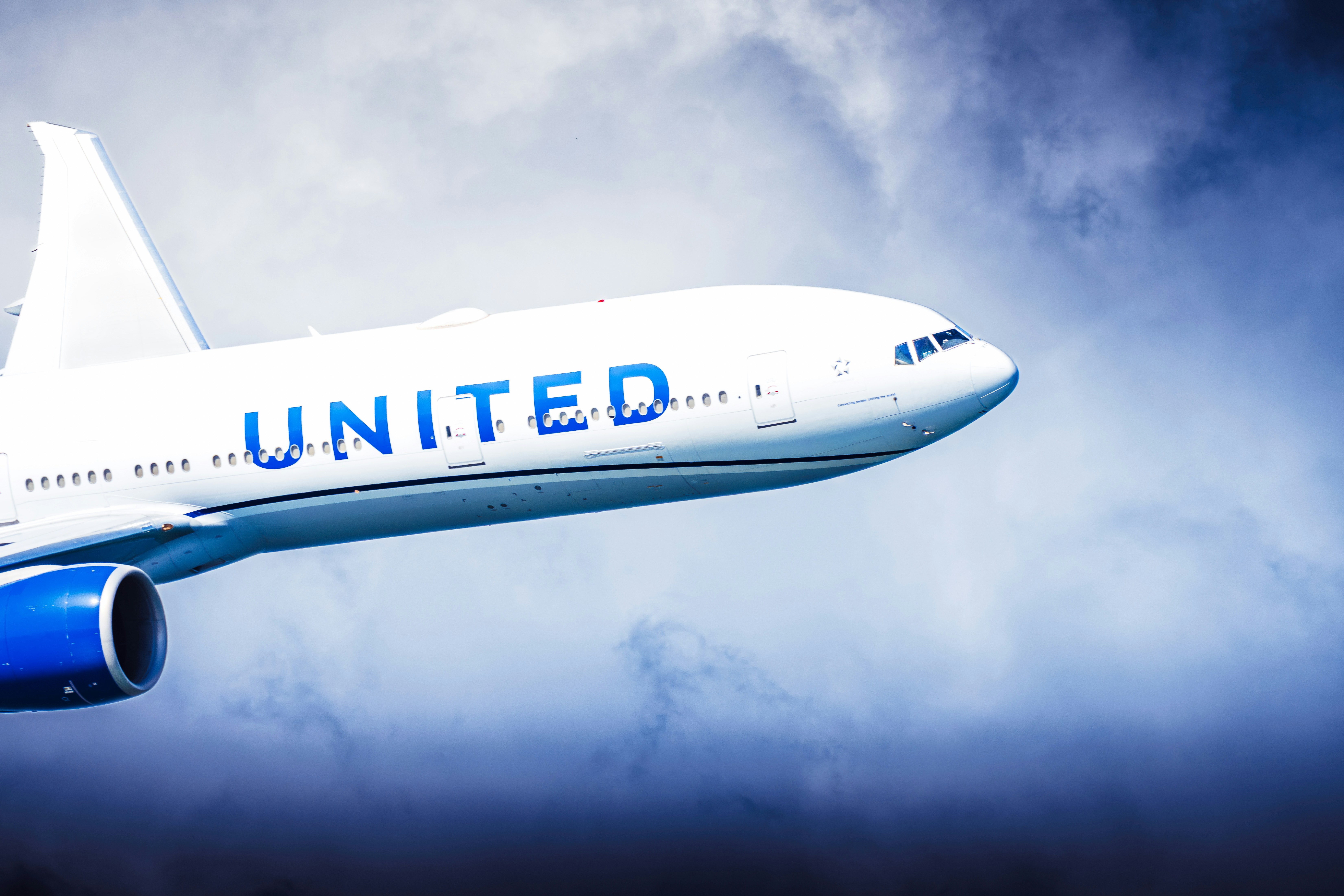 United airlines airplane flying through clouds