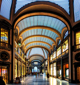Grand arched walkway with shops and skylights