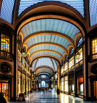 Grand arched walkway with shops and skylights