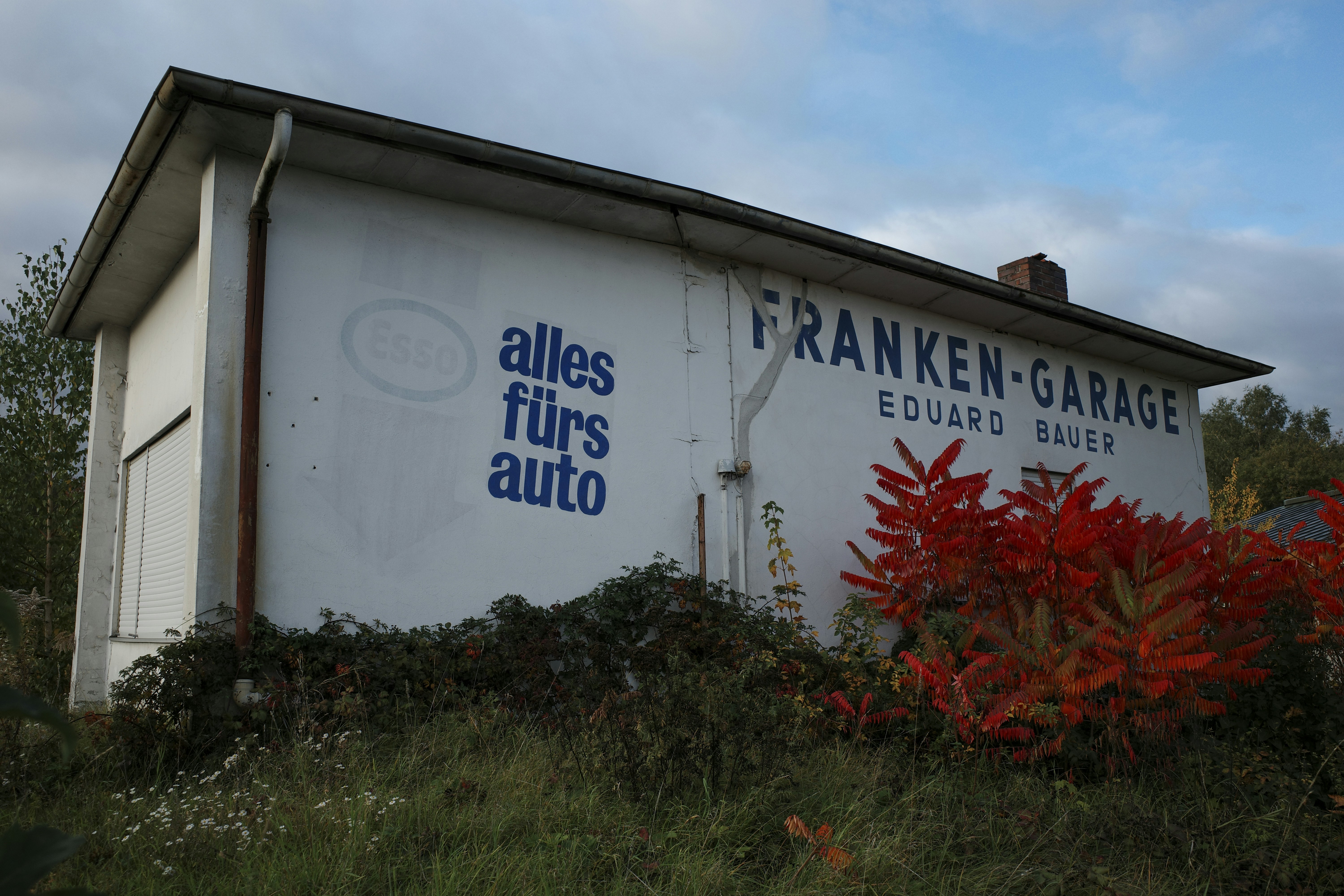 White building with "franken-garage" sign