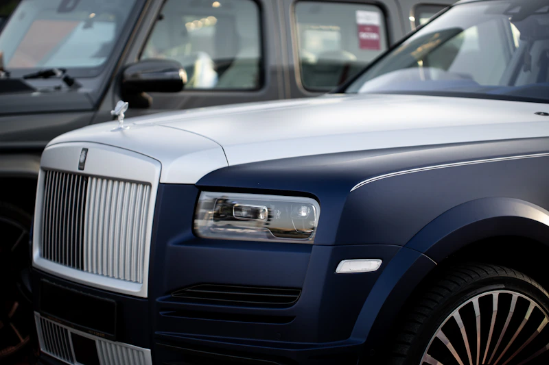 Two luxury cars parked side by side, ultimate status