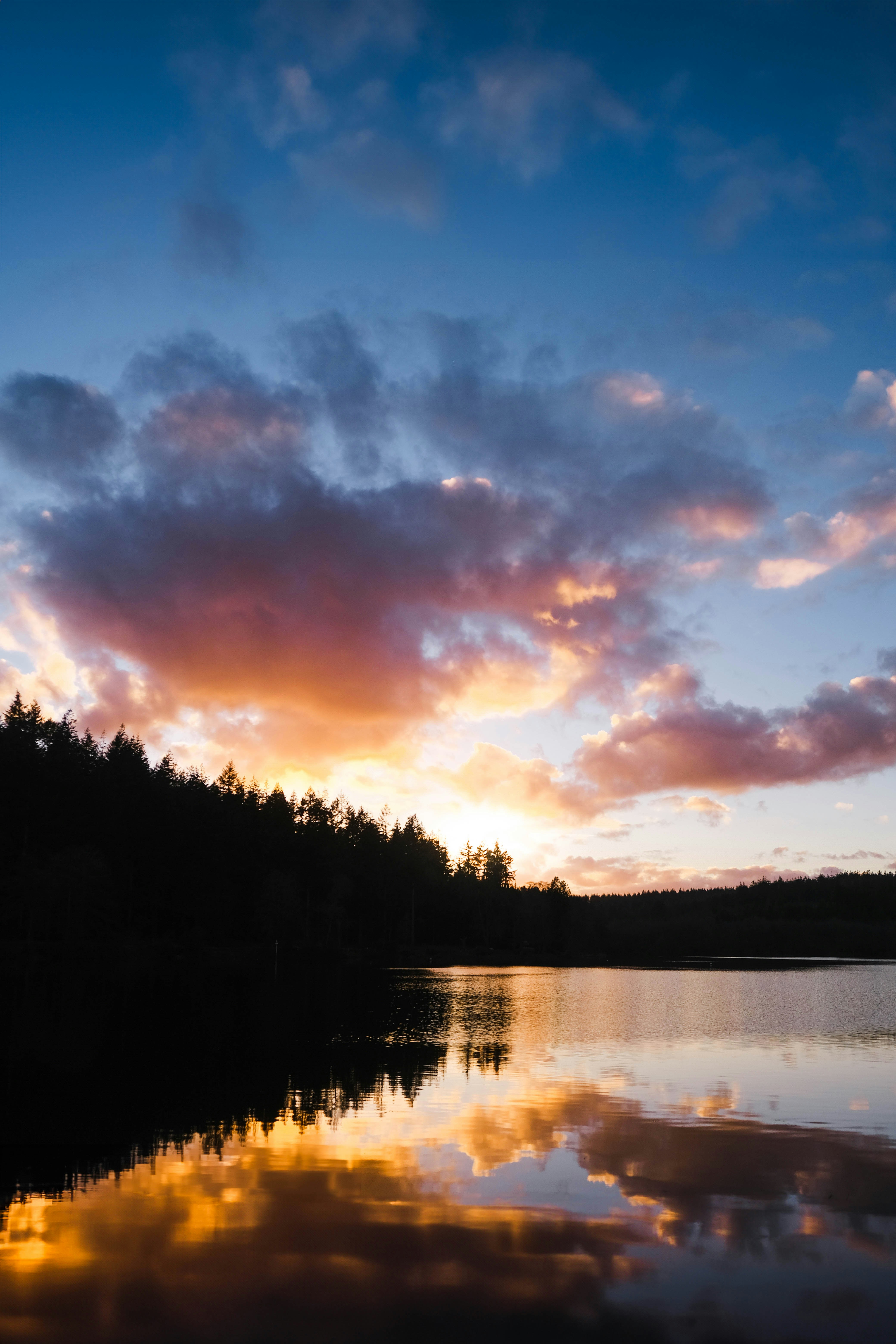 Sunset over a calm lake with colorful clouds