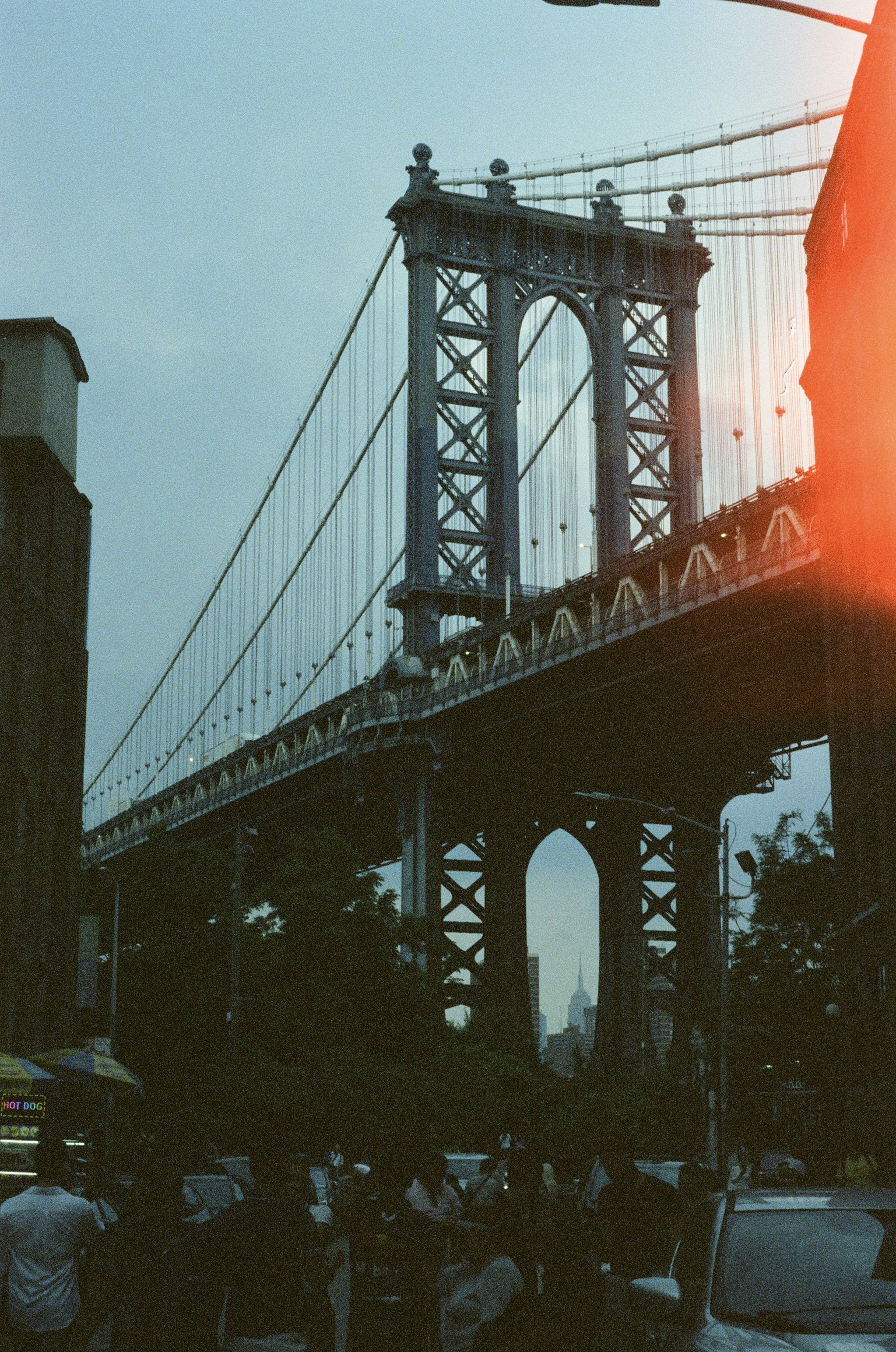 Manhattan bridge spanning over trees and street