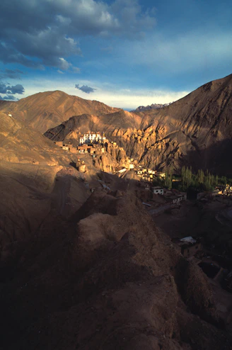 Monastery buildings nestled in a rugged mountain landscape.