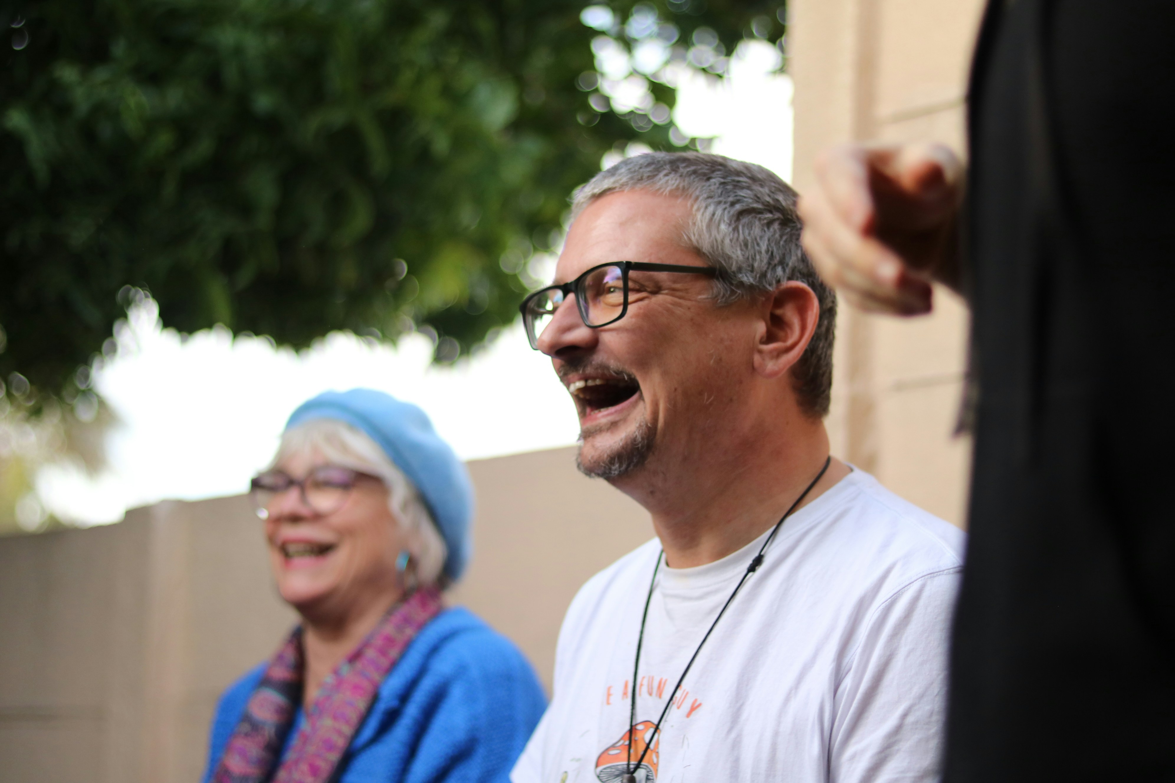 Man and woman laughing outdoors