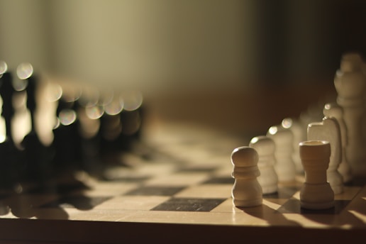Chess pieces lined up on a chessboard