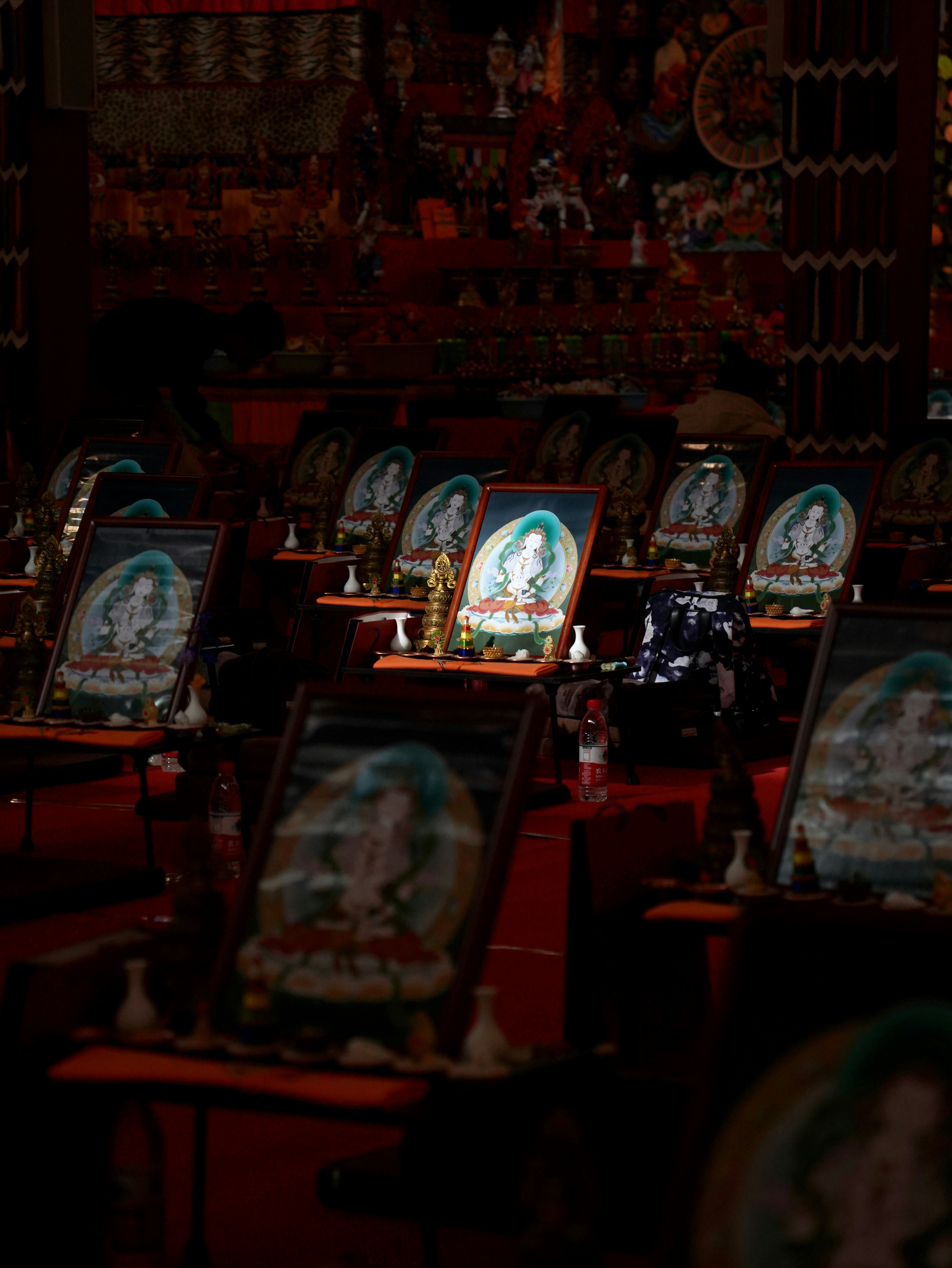 Rows of framed religious art with ornate decorations.