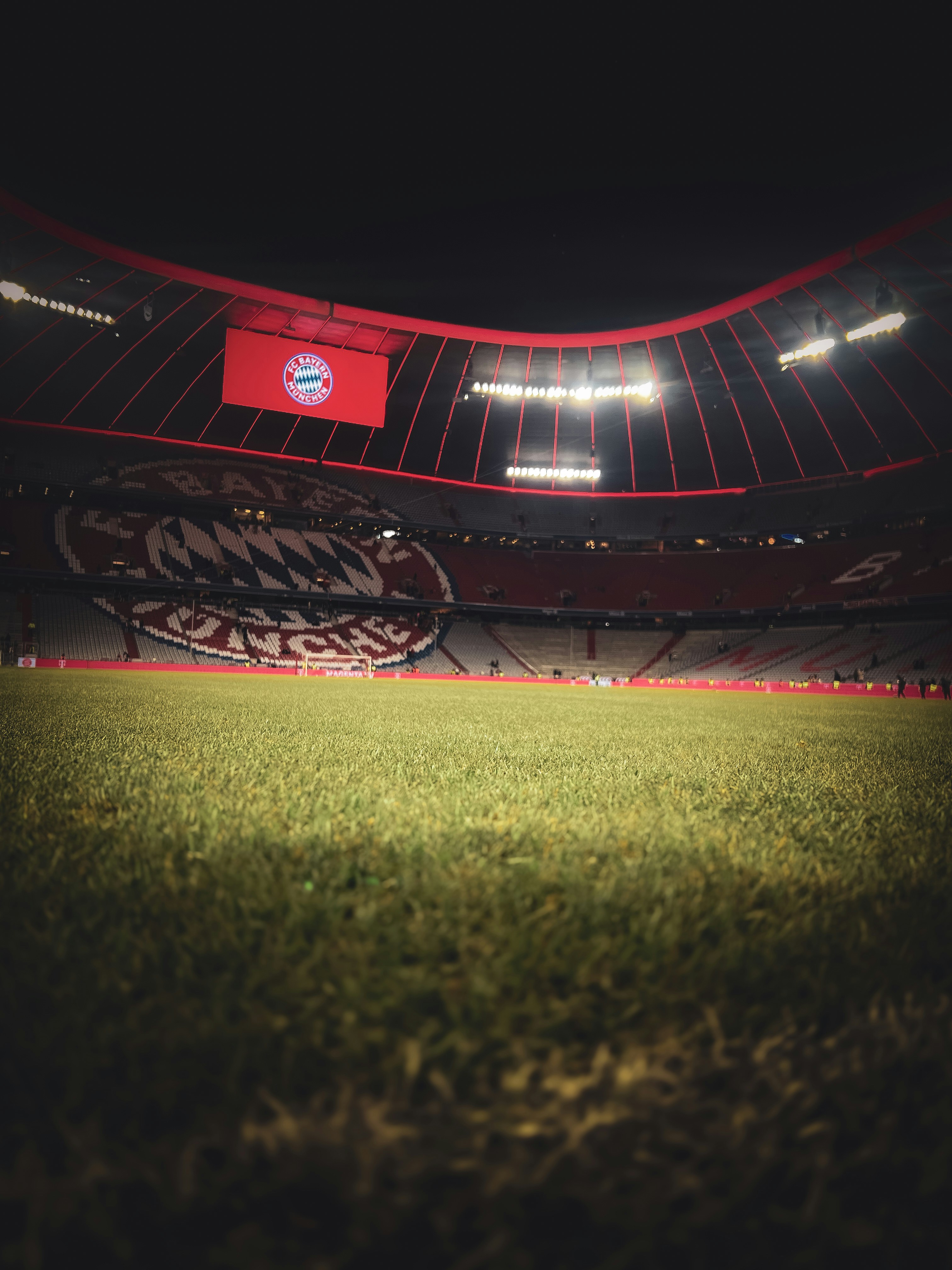 Empty soccer stadium with red seats and lights