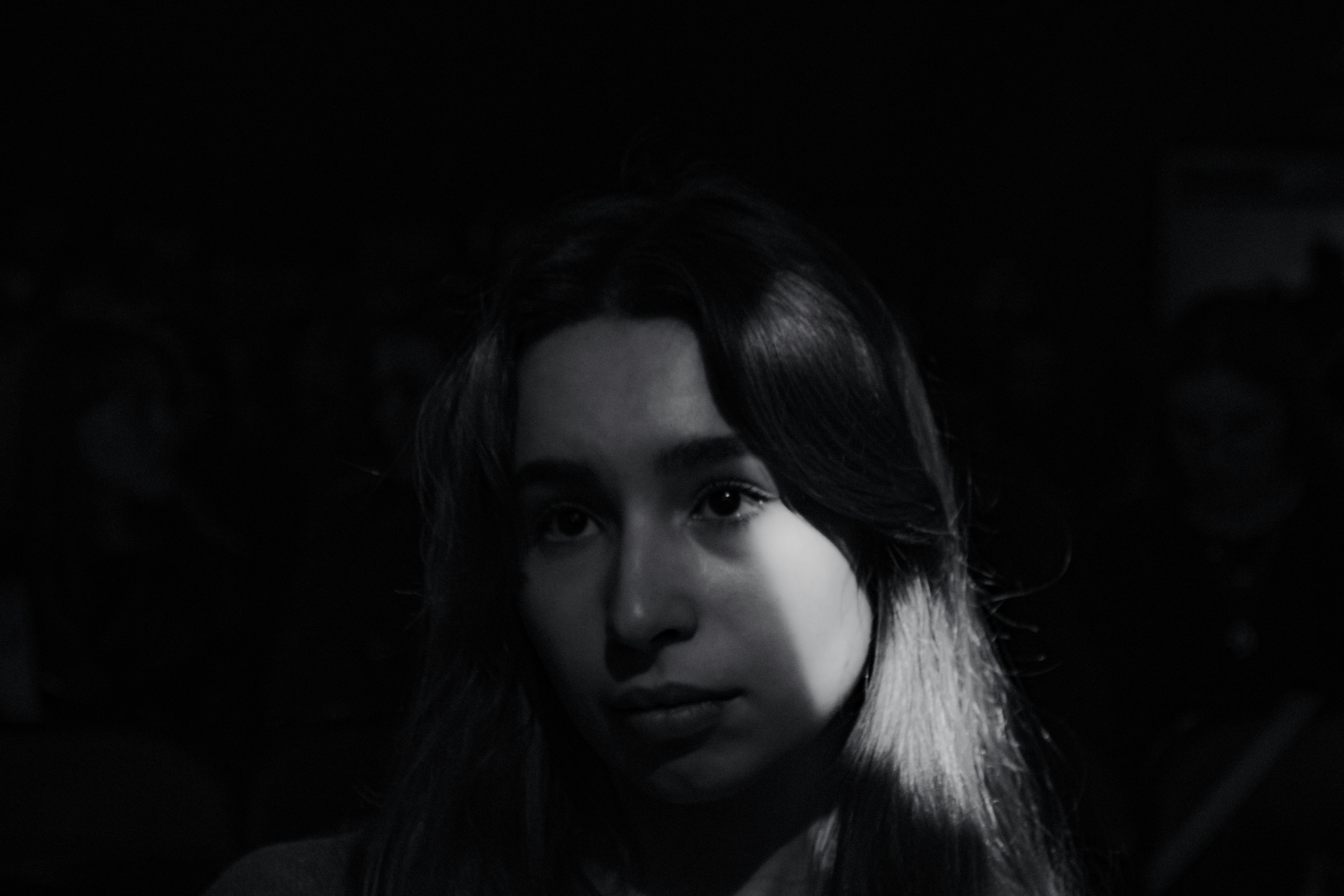 Young woman in dramatic light and shadow