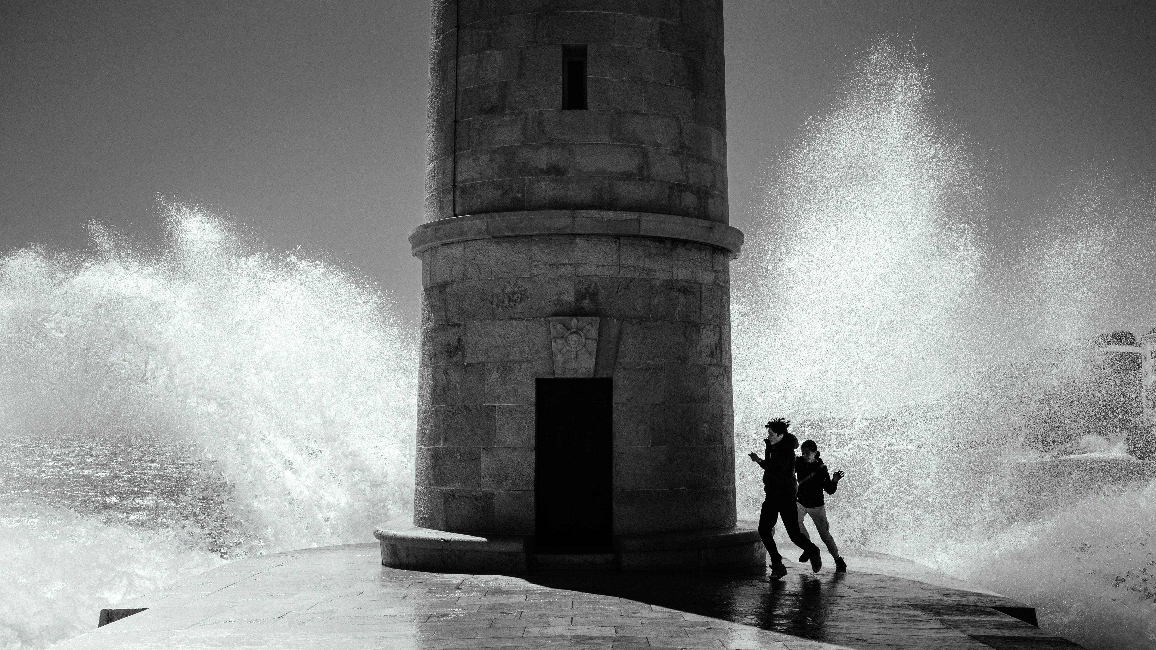 On a crisp spring morning, I was admiring the view and the ocean in Cassis. While wandering around, I found this lighthouse where kids were trying to play hide and seek with the ocean waves. A sudden crashing of a huge ocean wave took the kids by surprise. It was a joyful sight to see them try and hide behind the lighthouse.