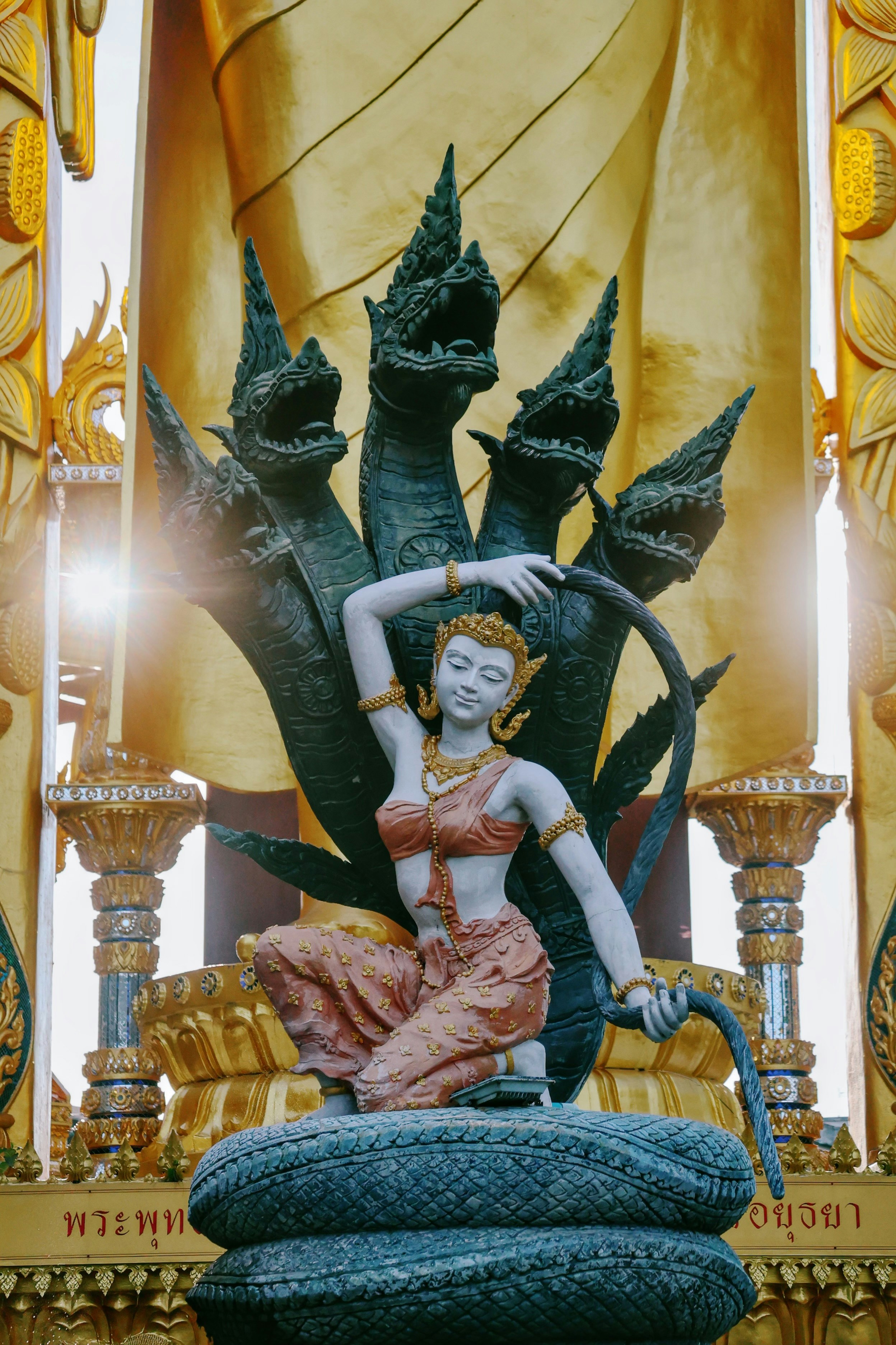 A statue of a woman with a multi-headed serpent