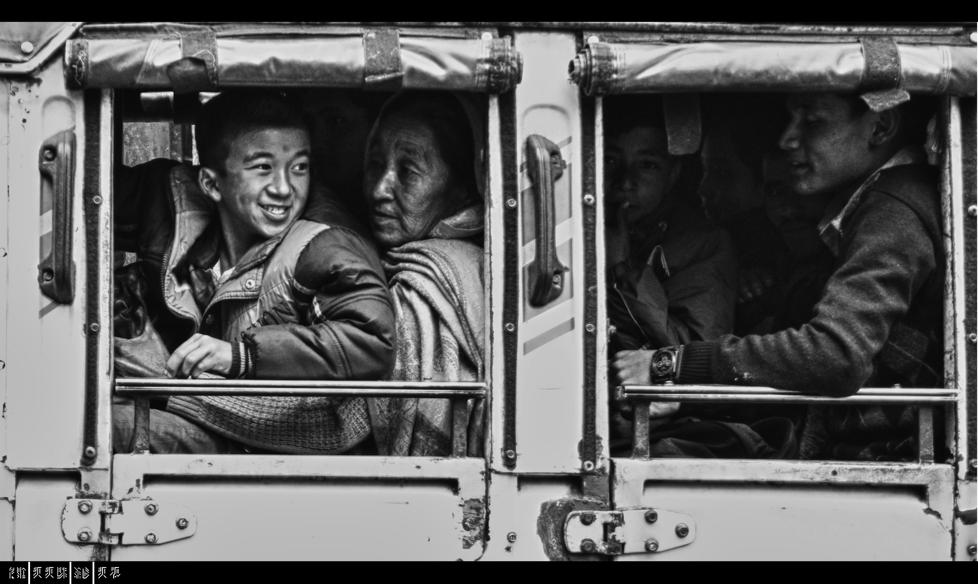 People in a truck looking out windows.