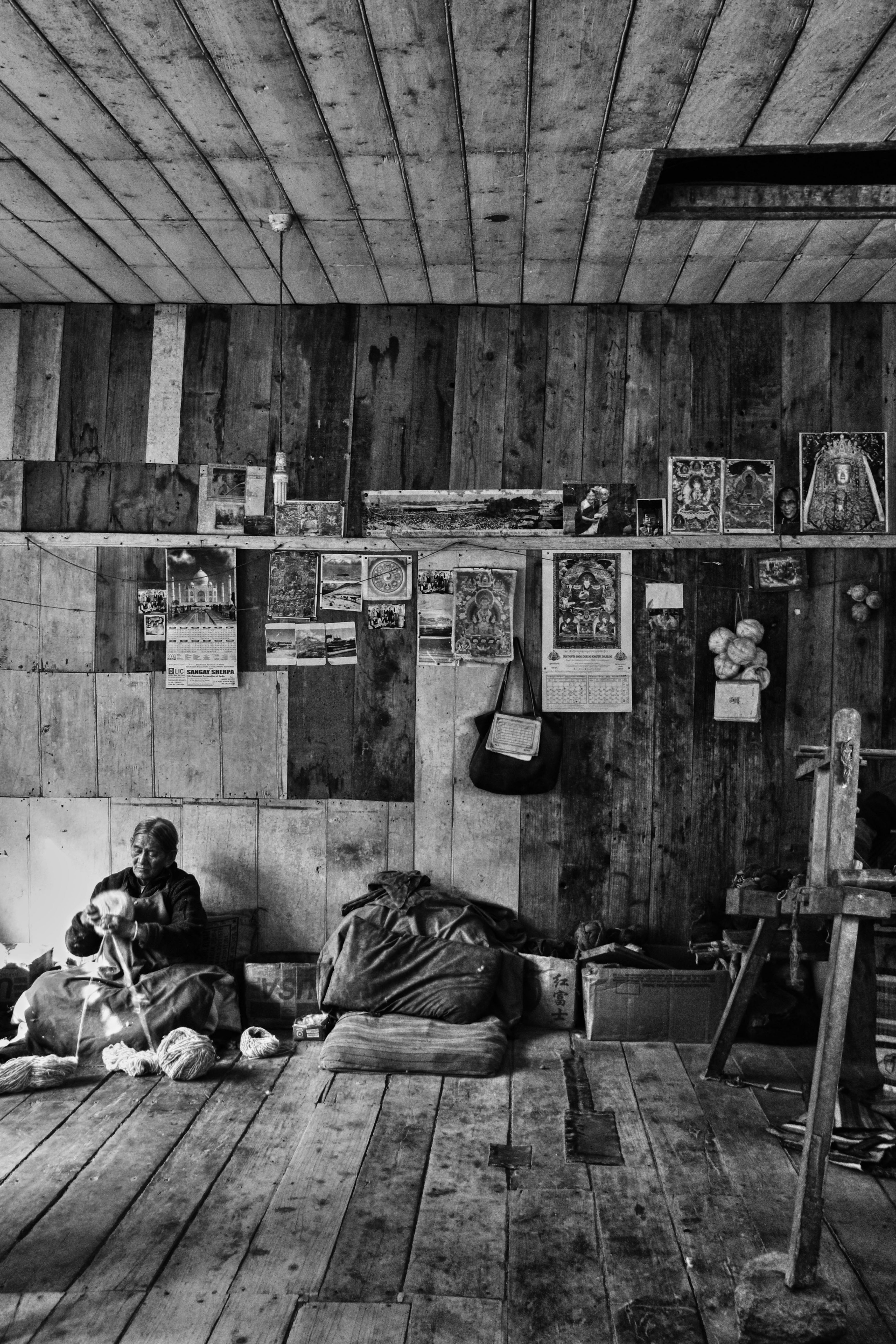 Elderly man sitting in a rustic wooden room