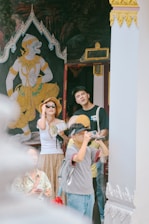 Tourists looking at mural art inside a temple