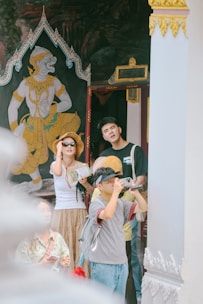 Tourists looking at mural art inside a temple