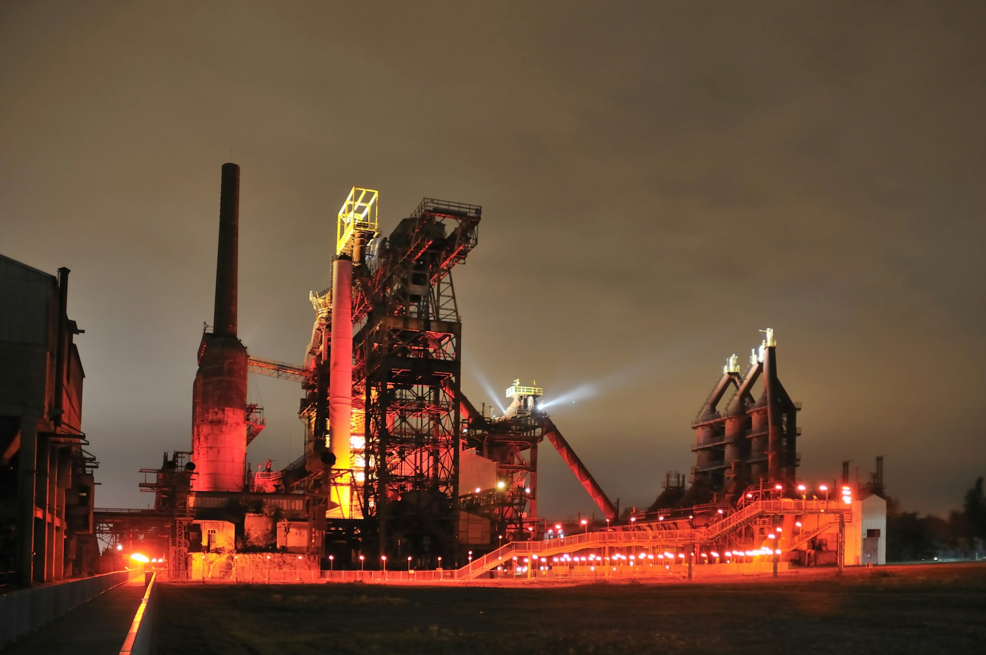 Industrial complex illuminated at night with red lights