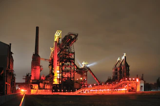 Industrial complex illuminated at night with red lights