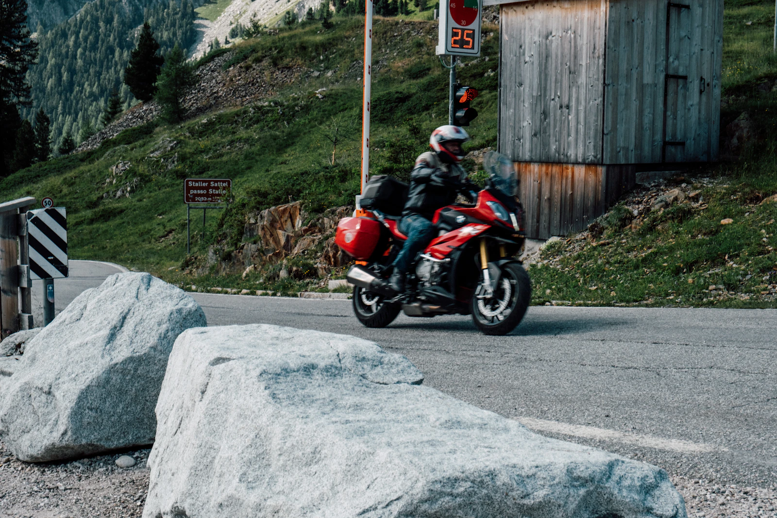 Motorcyclist leaning into a switchback on a mountain road