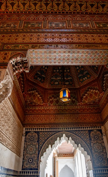 Intricate moroccan ceiling with geometric patterns and lantern.