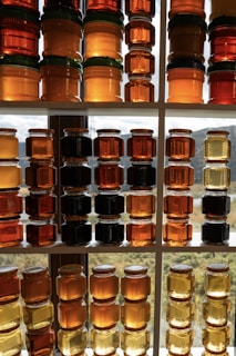 Jars of golden honey stacked on shelves
