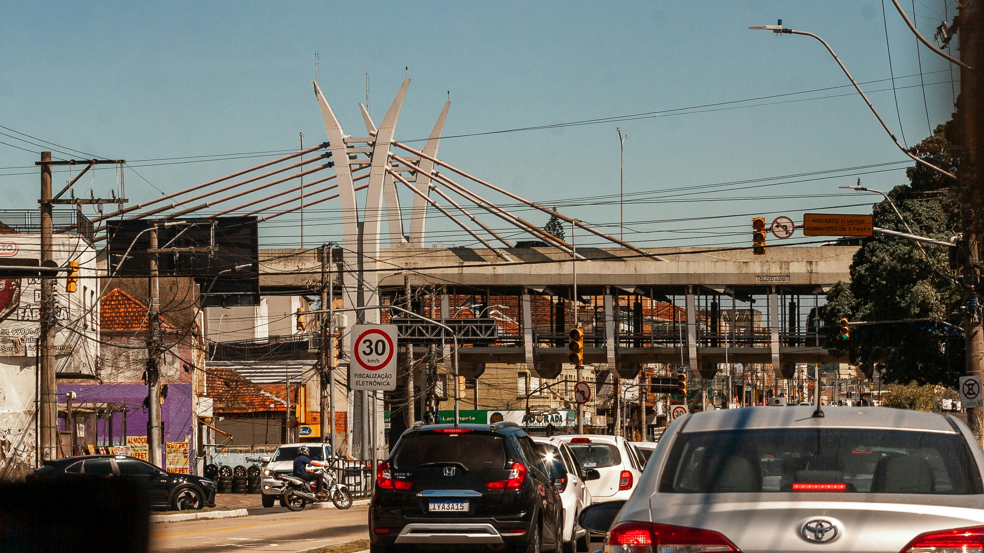 Traffic jam on a city street with bridge in background