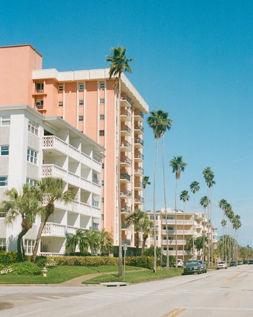Palm-lined street with mid-rise apartment buildings in St. Petersburg, Florida