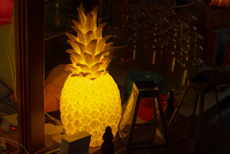 Illuminated pineapple lamp in a dimly lit room