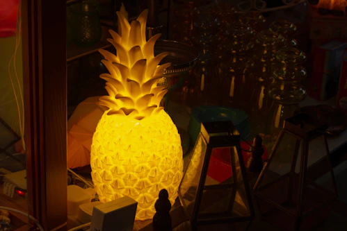 Illuminated pineapple lamp in a dimly lit room