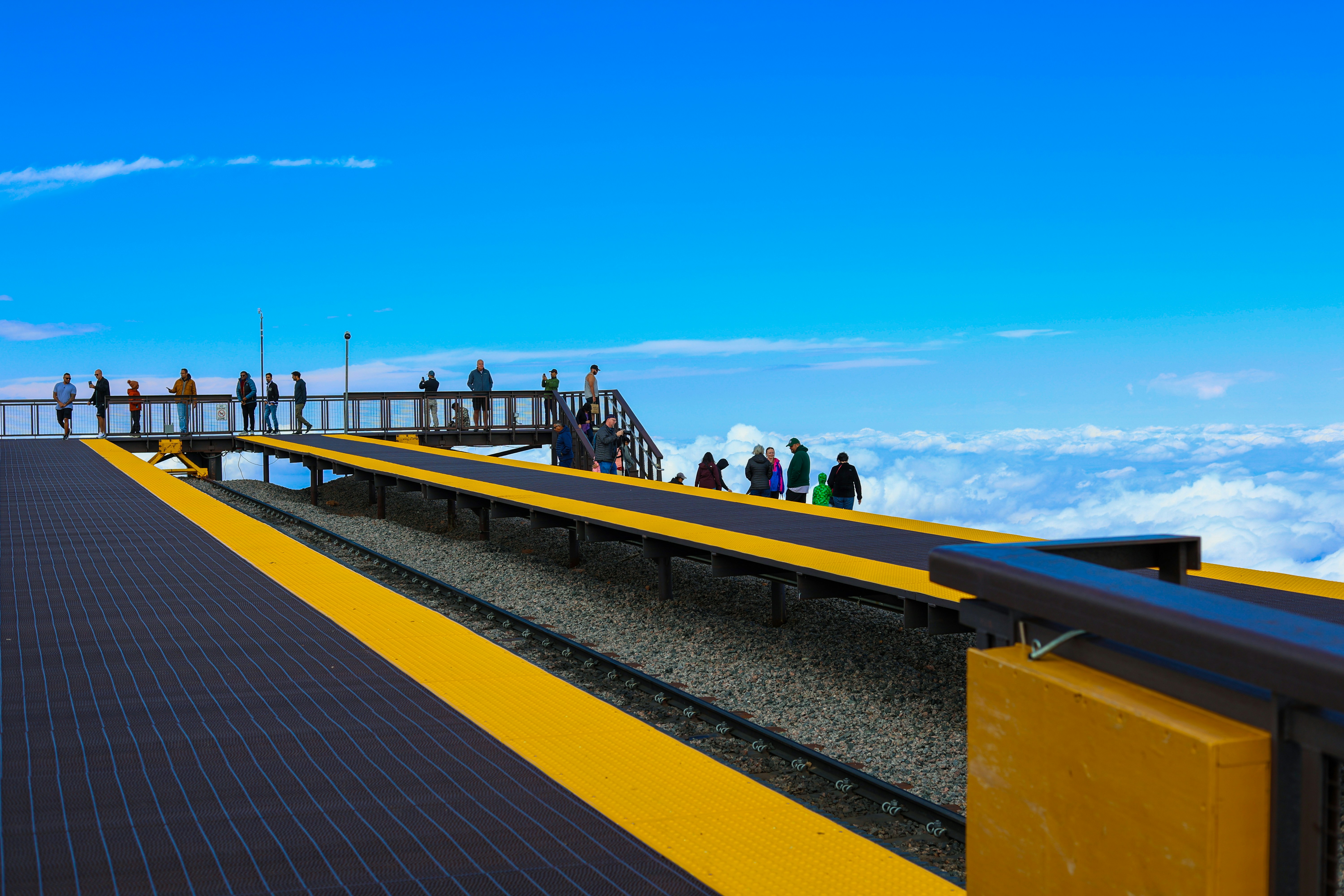 People on observation deck above clouds