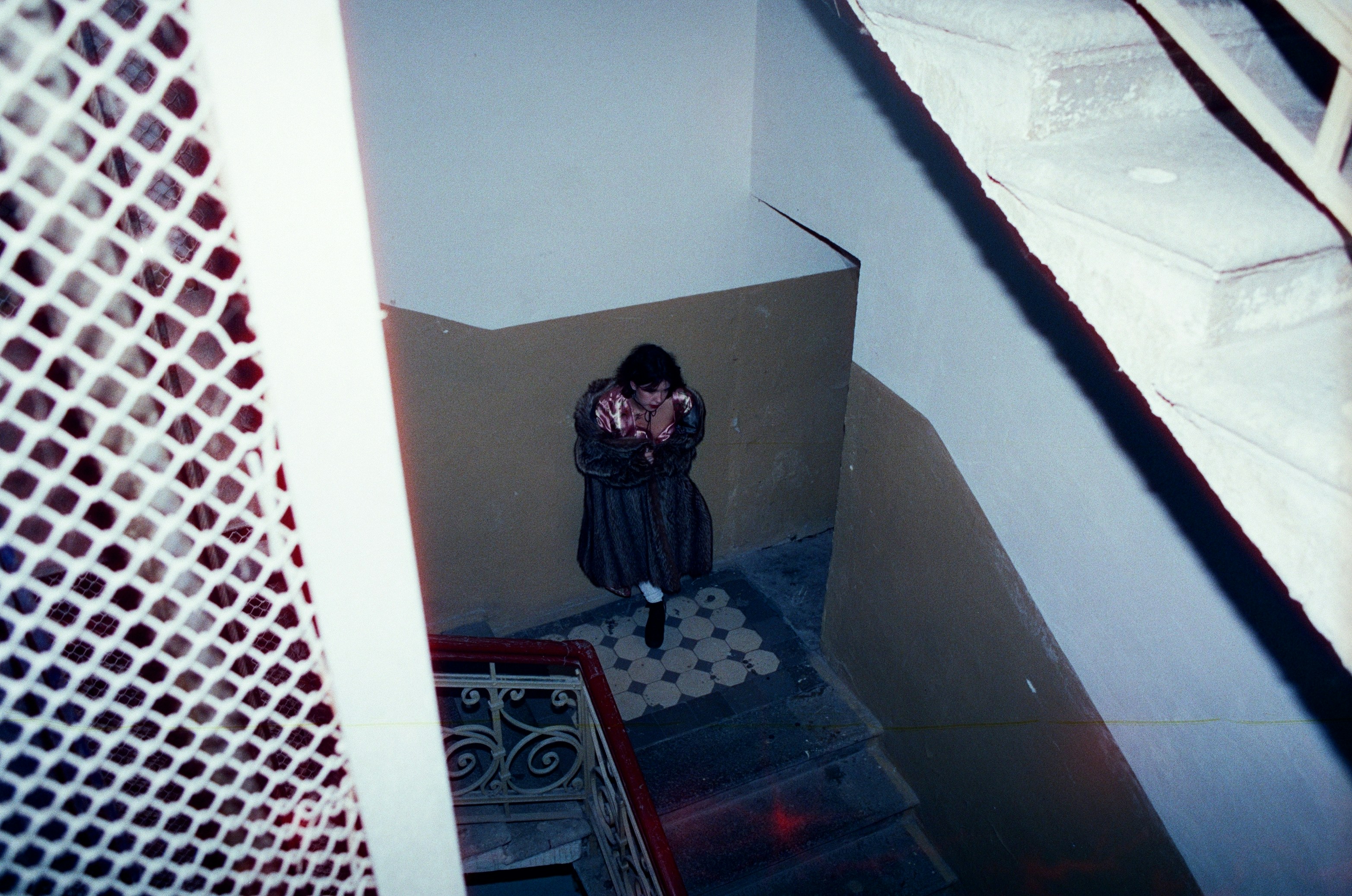 A person stands on a staircase landing.