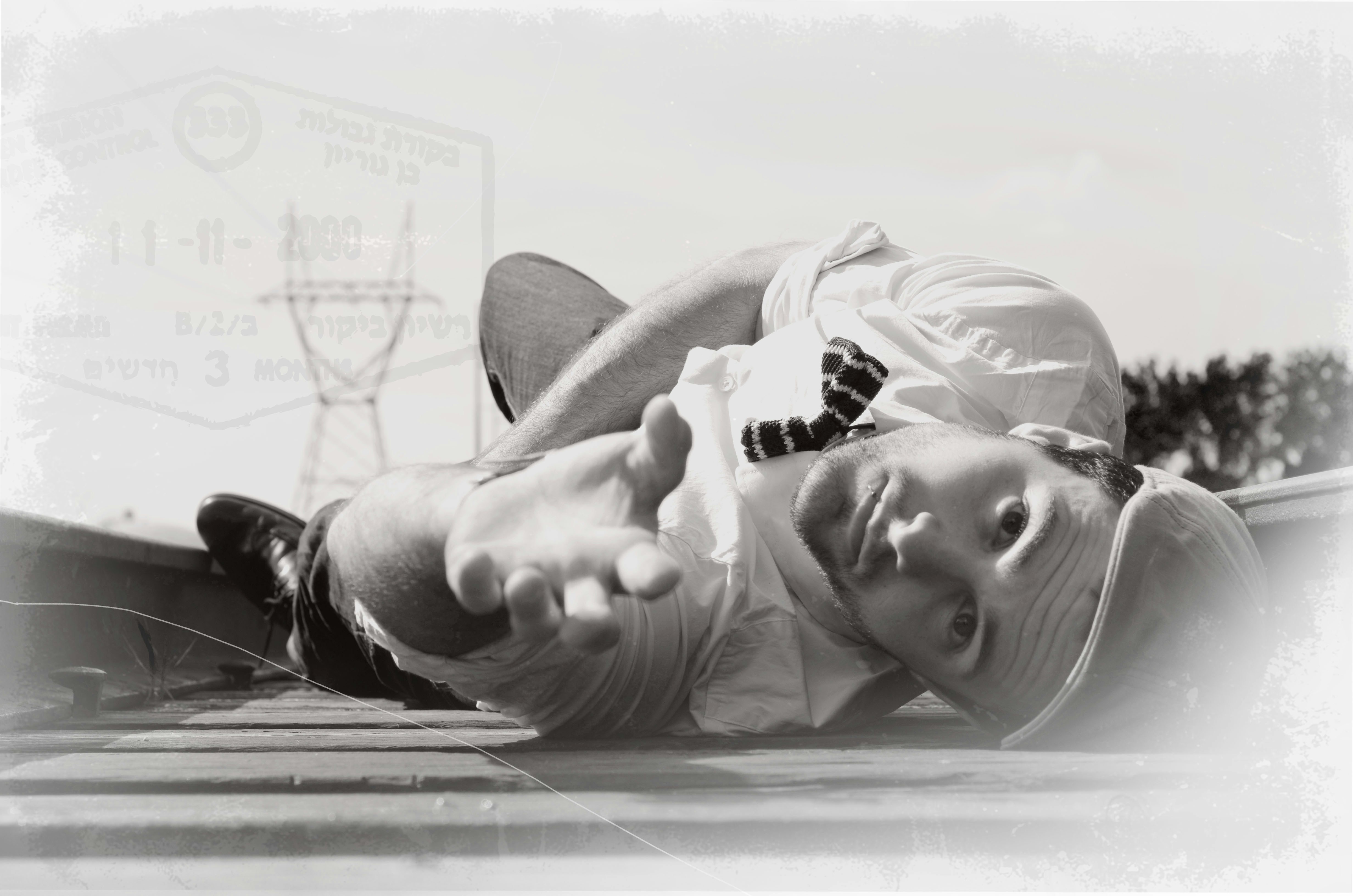 Person stretching their arms and legs, relaxing after a workout in a park.